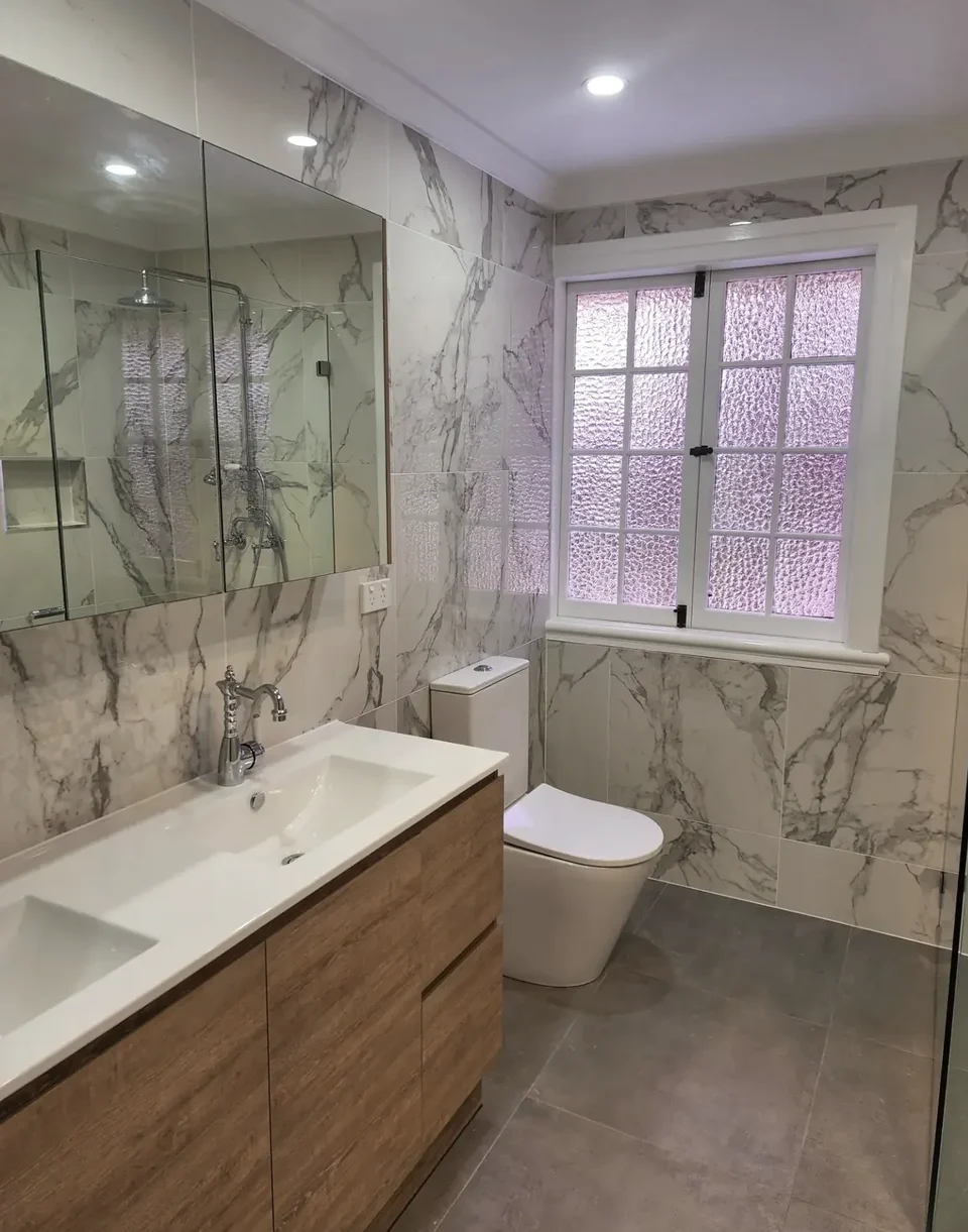 Bardon’s timber vanity, original window and full-height marble-look wall tiles